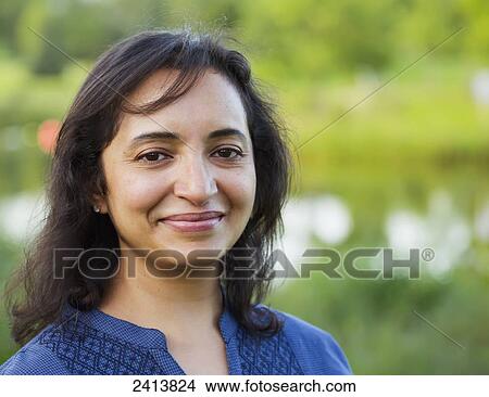 Picture - Portrait of a woman in a park; Edmonton, Alberta, Canada. Fotosearch