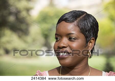 Portrait of a woman in a park; Edmonton, Alberta, Canada View Large Photo Image Picture - Portrait of a woman in a park; Edmonton, Alberta, Canada. Fotosearch