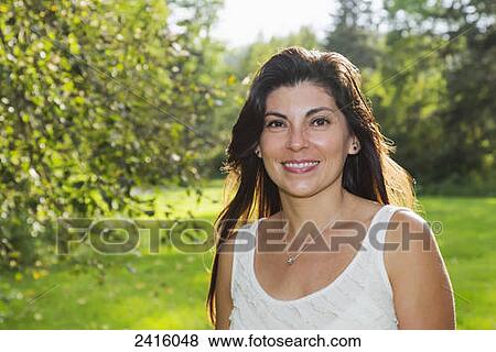 Stock Photo - Portrait of a woman in a park; Edmonton, Alberta, Canada. Fotosearch