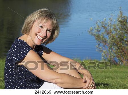 Portrait of a woman relaxing in Hawrelak Park; Edmonton, Alberta, Canada View Large Photo Image Stock Photo - Portrait of a woman relaxing in Hawrelak Park; Edmonton, Alberta, Canada. Fotosearch