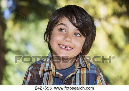 Portrait of a young boy with a missing tooth; Langley, British Columbia, Canada View Large Photo Image Stock Photography - Portrait of a young boy with a missing tooth; Langley, British Columbia, Canada. Fotosearch