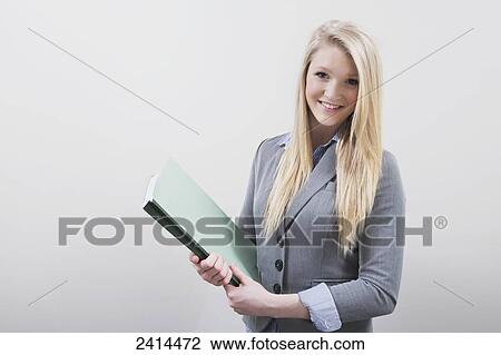 Portrait of a young businesswoman doing filing at an office; Edmonton, Alberta, Canada View Large Photo Image Stock Image - Portrait of a young businesswoman doing filing at an office; Edmonton, Alberta, Canada. Fotosearch
