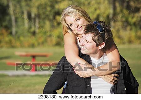 Portrait of a young couple in a park; Edmonton, Alberta, Canada View Large Photo Image Stock Image - Portrait of a young couple in a park; Edmonton, Alberta, Canada. Fotosearch