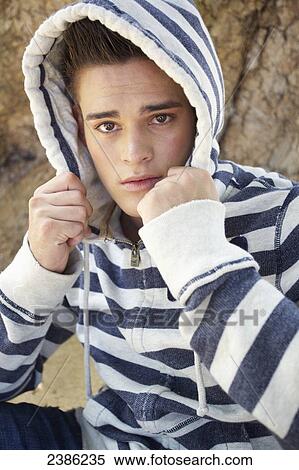 Portrait of a young man wearing a striped hood; Hawaii, United States of America View Large Photo Image Stock Photography - Portrait of a young man wearing a striped hood; Hawaii, United States of America. Fotosearch