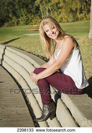 Portrait of a young woman enjoying a park; Edmonton, Alberta, Canada View Large Photo Image Stock Image - Portrait of a young woman enjoying a park; Edmonton, Alberta, Canada. Fotosearch