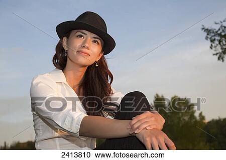 Portrait of a young woman enjoying an evening in a park; Edmonton, Alberta, Canada View Large Photo Image Stock Image - Portrait of a young woman enjoying an evening in a park; Edmonton, Alberta, Canada. Fotosearch