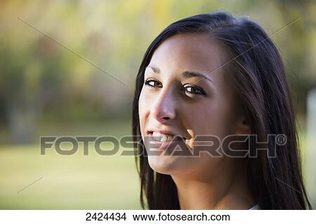 Picture - Portrait of a young woman in a park at dusk; Edmonton, Alberta, Canada. Fotosearch