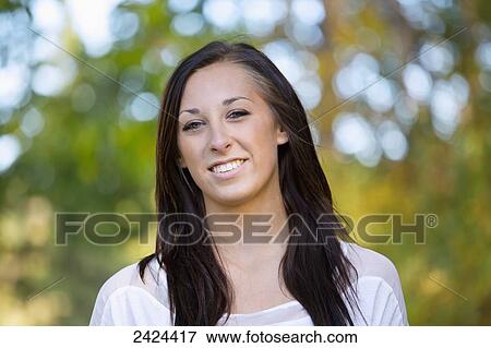 Portrait of a young woman in a park in autumn; Edmonton, Alberta, Canada View Large Photo Image Stock Photo - Portrait of a young woman in a park in autumn; Edmonton, Alberta, Canada. Fotosearch