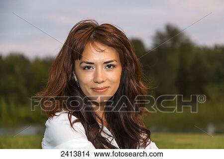 Picture - Portrait of a young woman in a park; Edmonton, Alberta, Canada. Fotosearch