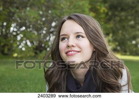 Portrait of a young woman in a park; Edmonton, Alberta, Canada View Large Photo Image Stock Photo - Portrait of a young woman in a park; Edmonton, Alberta, Canada. Fotosearch