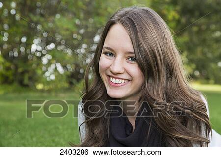 Stock Photograph - Portrait of a young woman in a park; Edmonton, Alberta, Canada. Fotosearch