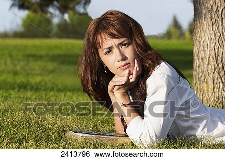 Portrait of a young woman in a park with her Bible; Edmonton, Alberta, Canada View Large Photo Image Stock Photograph - Portrait of a young woman in a park with her Bible; Edmonton, Alberta, Canada. Fotosearch