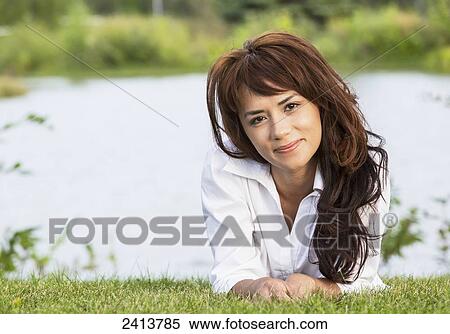 Stock Photography - Portrait of a young woman in a park; Edmonton, Alberta, Canada. Fotosearch