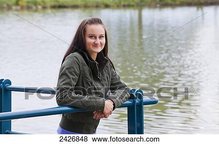 Portrait of a young woman on a pier; St. Albert, Alberta, Canada View Large Photo Image Stock Photo - Portrait of a young woman on a pier; St. Albert, Alberta, Canada. Fotosearch