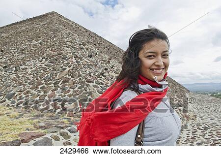 Portrait of a young woman standing at the base of a pyramid; San Juan Teotihuacan, State of Mexico, Mexico View Large Photo Image Stock Photograph - Portrait of a young woman standing at the base of a pyramid; San Juan Teotihuacan, State of Mexico, Mexico. Fotosearch
