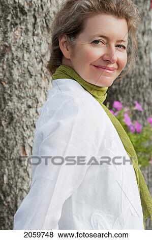 Portrait Of Woman Leaning Against Tree, Manitoba, Canada View Large Photo Image Stock Photo - Portrait Of Woman Leaning Against Tree, Manitoba, Canada. Fotosearch