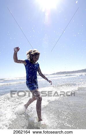 Pre-Teen Girl Running On Beach, Vancouver Island, B. C. View Large Photo Image Picture - Pre-Teen Girl Running On Beach, Vancouver Island, B. C.. Fotosearch