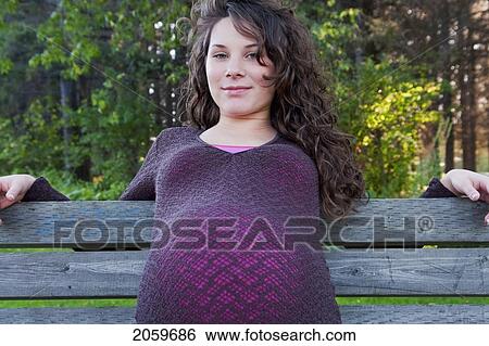 Pregnant Woman Seated On Bench, Manitoba, Canada View Large Photo Image Stock Photograph - Pregnant Woman Seated On Bench, Manitoba, Canada. Fotosearch