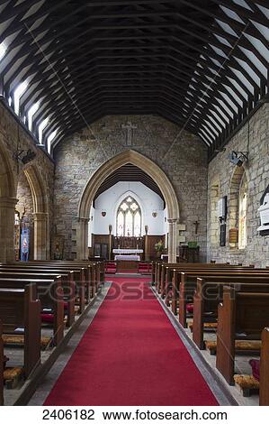 Stock Image - Red carpet down the aisle of a church leading to the altar; Helmsley, North Yorkshire, England. Fotosearch
