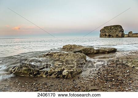 Rocks at the water's edge along the coast at sunset; South Shields, Tyne and Wear, England View Large Photo Image Stock Image - Rocks at the water's edge along the coast at sunset; South Shields, Tyne and Wear, England. Fotosearch