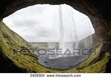 Seljalandsfoss waterfall, photographed from behind the water; Iceland View Large Photo Image Picture - Seljalandsfoss waterfall, photographed from behind the water; Iceland. Fotosearch
