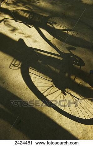 Shadow of a parked bicycle on a walkway; Ulpotha, Embogama, Sri Lanka View Large Photo Image Stock Image - Shadow of a parked bicycle on a walkway; Ulpotha, Embogama, Sri Lanka. Fotosearch