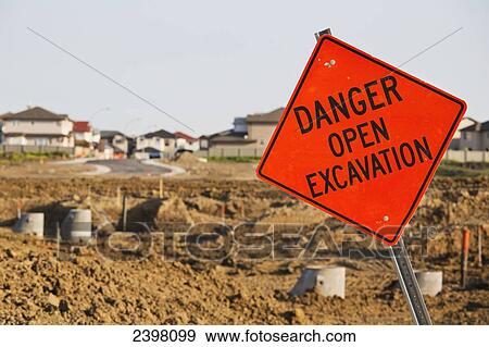 Stock Photo - Sign warning of danger at the construction site of new development; Edmonton, Alberta, Canada. Fotosearch