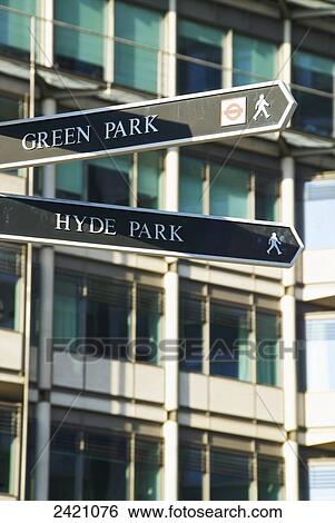 Stock Photograph - Signs for Green Park and Hyde Park with a building in the background; London, England. Fotosearch