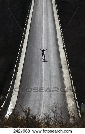Stock Photo - Silhouette of man on high bridge; Lijiang, Yunnan Province, China. Fotosearch