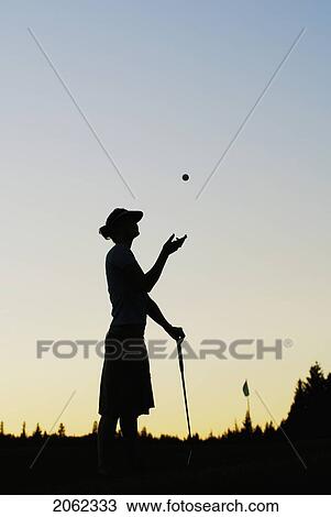 Stock Image - Silhouette Of Young Woman On Organic Golf Course, Clear Lake Golf Course, Riding Mountain National Park, Manitoba, Canada. Fotosearch