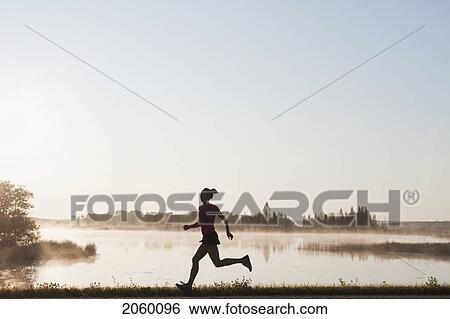 Silohuette Of Woman Running By Lakeshore, Clear Lake, Riding Mountain National Park, Manitoba, Canada View Large Photo Image Stock Photograph - Silohuette Of Woman Running By Lakeshore, Clear Lake, Riding Mountain National Park, Manitoba, Canada. Fotosearch