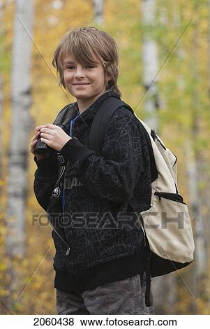 Stock Photo - Smiling 10 Year Old Boy With Binoculars And Hemp Backpack, Lake Katherine, Riding Mountain National Park, Manitoba. Fotosearch