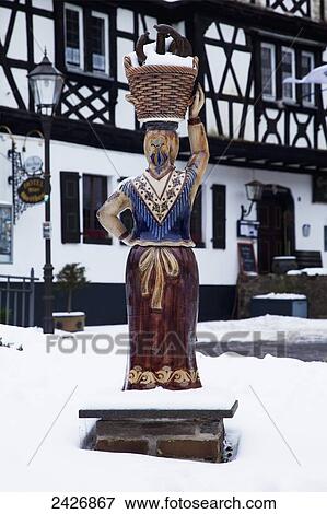 Stock Photo - Snow covers the ground and a statue in winter; Grenzau, Rheinland-Pfalz, Germany. Fotosearch