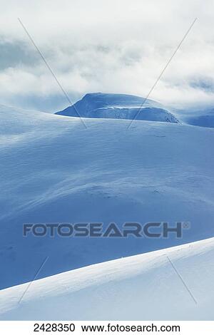 Stock Image - Snowy hills as seen from Geal Charn, near Laggan; Scotland. Fotosearch