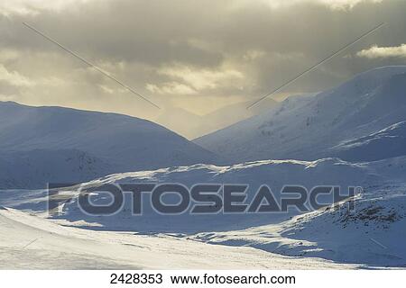 Stock Image - Snowy hills as seen from Geal Charn, near Laggan; Scotland. Fotosearch