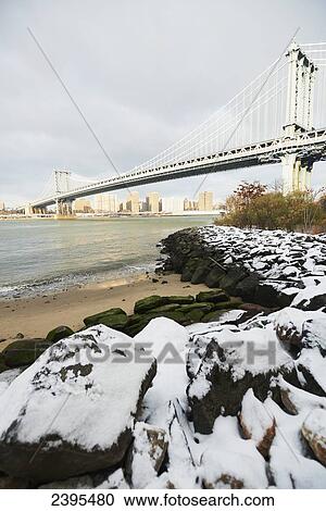 Snowy waterfront in Brooklyn Bridge Park looking towards Manhattan bridge; New York City, New York, United States of America View Large Photo Image Stock Image - Snowy waterfront in Brooklyn Bridge Park looking towards Manhattan bridge; New York City, New York, United States of America. Fotosearch