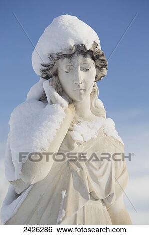 Statue of a woman covered in snow in Burnsland Cemetery; Calgary, Alberta, Canada View Large Photo Image Stock Photograph - Statue of a woman covered in snow in Burnsland Cemetery; Calgary, Alberta, Canada. Fotosearch