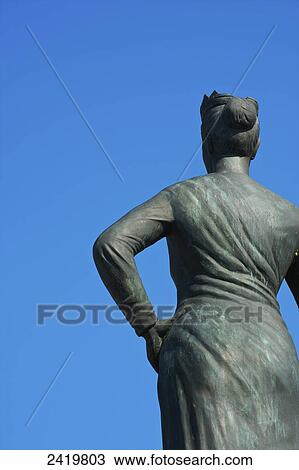 Statue of female likeness against a blue sky; Hamburg, Germany View Large Photo Image Stock Image - Statue of female likeness against a blue sky; Hamburg, Germany. Fotosearch
