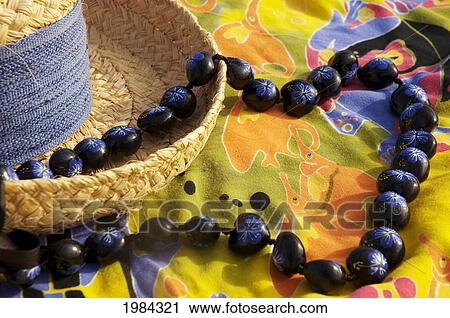 Straw Hat With Blue Band On Colorful Pareo (Sarong) With Hand Painted Kukui Nut Lei. View Large Photo Image Stock Image - Straw Hat With Blue Band On Colorful Pareo (Sarong) With Hand Painted Kukui Nut Lei.. Fotosearch