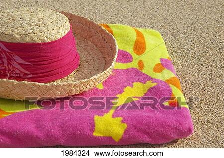 Straw Hat With Dark Pink Band On Multi-Colored Towel On Sand. View Large Photo Image Picture - Straw Hat With Dark Pink Band On Multi-Colored Towel On Sand.. Fotosearch