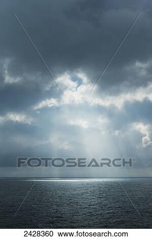 Sunlight coming through clouds on ferry between Dover and Calais; England View Large Photo Image Stock Image - Sunlight coming through clouds on ferry between Dover and Calais; England. Fotosearch