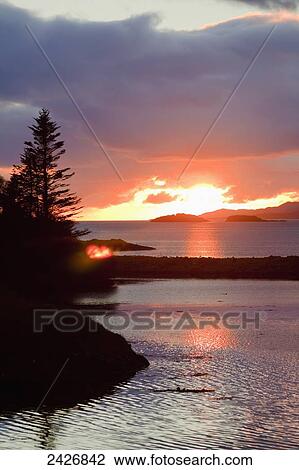 Stock Image - Sunset at Rosdohan Pier, near Sneem; County Kerry, Ireland. Fotosearch