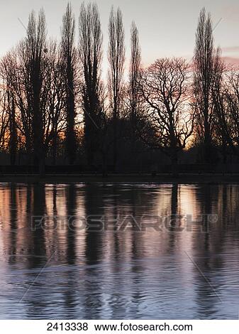 Sunset on the River Thames at Kingston upon Thames; Surrey, England View Large Photo Image Stock Photo - Sunset on the River Thames at Kingston upon Thames; Surrey, England . Fotosearch