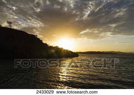 Sunset over Kima Bay, Rinca Island, Komodo National Park, East Nusa Tenggara, Indonesia View Large Photo Image Stock Photo - Sunset over Kima Bay, Rinca Island, Komodo National Park, East Nusa Tenggara, Indonesia. Fotosearch