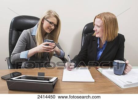Stock Photography - Supervisor teaching intern about accounting practises; Edmonton, Alberta, Canada. Fotosearch - Search Stock Photos, Pictures, Wall Murals, Images, and Photo Clipart