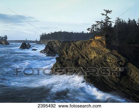 Stock Image - Surf erodes the Oregon coastline; Charleston, Oregon, United States of America. Fotosearch