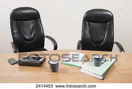 Stock Image - Table and chairs in an accounting office with a tablet and documents; Edmonton, Alberta, Canada. Fotosearch