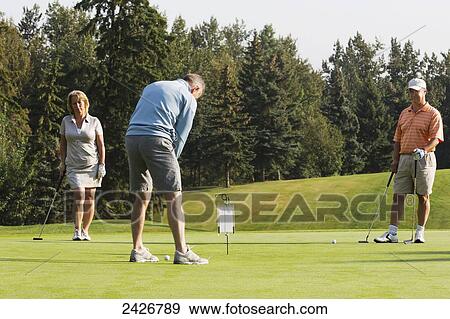 Team of golfers in a golf tournament; Edmonton, Alberta, Canada View Large Photo Image Stock Photo - Team of golfers in a golf tournament; Edmonton, Alberta, Canada. Fotosearch