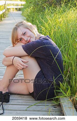 Teen Seated On Boardwalk In Marsh, Riding Mountain National Park, Manitoba, Canada View Large Photo Image Stock Photo - Teen Seated On Boardwalk In Marsh, Riding Mountain National Park, Manitoba, Canada. Fotosearch