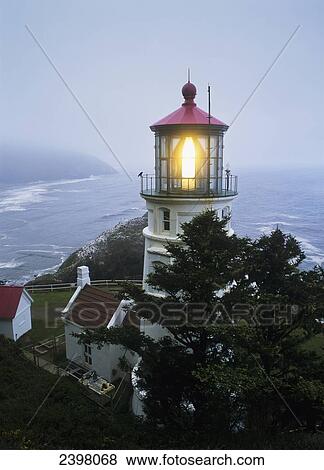 The Heceta Head Lighthouse flashes on a foggy morning; Florence, Oregon, United States of America View Large Photo Image Stock Photo - The Heceta Head Lighthouse flashes on a foggy morning; Florence, Oregon, United States of America. Fotosearch